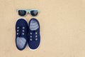 Blue sneakers and sunglasses. Summer holidays Royalty Free Stock Photo