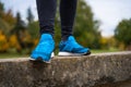 Blue sneakers on a woman legs