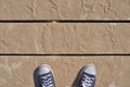 Blue sneakers on wooden boards covered with sand Royalty Free Stock Photo