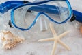 Blue snorkel mask with shells on the sand Royalty Free Stock Photo