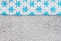 Blue snowflakes on gray plush material holiday background
