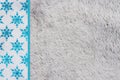 Blue snowflakes on gray plush material holiday background