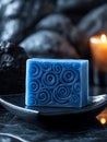 Blue soap with swirl design and candle in spa setting. Royalty Free Stock Photo