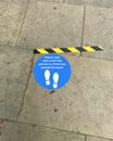 Blue Social Distancing floor sign outside London supermarket lockdown