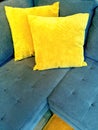 Blue sofa with bright yellow cushions Royalty Free Stock Photo