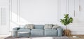 Blue sofa in contemporary living room, minimal design with empty white wall Royalty Free Stock Photo