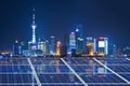 Blue solar cell panels,Shanghai skyline illuminated at night