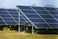 Blue solar panels photovoltaics power station with trees in background Royalty Free Stock Photo