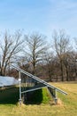 Blue solar panels photovoltaics power station with trees in background Royalty Free Stock Photo