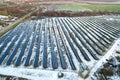 Blue solar photo voltaic panels system producing renewable clean energy in rural area in winter Royalty Free Stock Photo