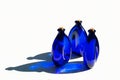 Blue solar water in blue glass bottles on white. Royalty Free Stock Photo