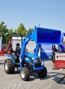 Blue Solis tractor with front loader at exhibition Royalty Free Stock Photo