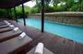 Blue spa resort poolside chaise lounges