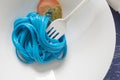 Blue spaghetti, black place setting