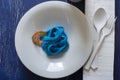 Blue spaghetti, black place setting