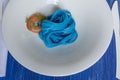 Blue spaghetti, black place setting