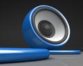 Blue speaker with cable over grey Royalty Free Stock Photo