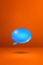 Blue speech bubble on orange vertical background Royalty Free Stock Photo
