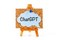 A blue speech bubble with word ChatGPT on a corkboard on a wooden easel Royalty Free Stock Photo
