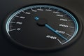 Blue speedometer in car on dashboard.