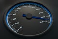 Blue speedometer in car on dashboard