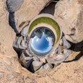 Blue sphere little planet inside gravel road and pebbles. curvature of space Royalty Free Stock Photo