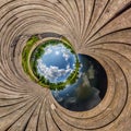 Blue sphere little planet inside transformation of wooden pier and lake Royalty Free Stock Photo