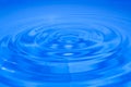 Blue Spherical drops of water floating above the water surface