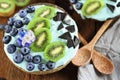 Blue Spirulina and Berry Smoothie Bowl with Blueberries and Kiwi Royalty Free Stock Photo