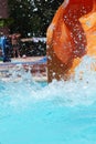 splashes of water from pool flying in all directions because of kid who moved down from water slide Royalty Free Stock Photo