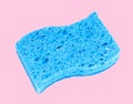Blue sponge on pastel pink background Royalty Free Stock Photo