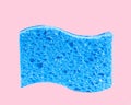 Blue sponge on pastel pink background Royalty Free Stock Photo