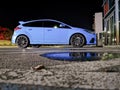 Blue sport car ford focus at parking in the nigh