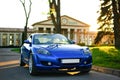 Blue Sport Car Parked on the Street on Airport s Building Background, Front View Royalty Free Stock Photo