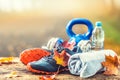 Blue sport shoes and water laid on a wooden board. Royalty Free Stock Photo