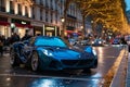 A blue sports car is parked on the side of the road, its sleek design catching the eye of passersby, A shiny, blue sports car Royalty Free Stock Photo
