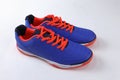 blue sports shoes with orange laces and a white sole. Royalty Free Stock Photo