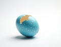 Blue spotted easter egg cracked open on white background. Light blue eggshell broken revealing inner texture. Empty shell ready Royalty Free Stock Photo