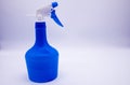 Blue spray bottle on white background
