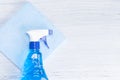 Blue spray for washing glasses lies on a rag