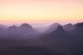 Blue spring daybreak. Sandstone cliff above deep misty valley in Saxony Switzerland. Hilly peaks Royalty Free Stock Photo