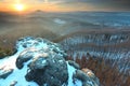 Blue spring daybreak, thawing of last snow. Sandstone cliff