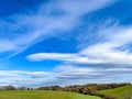 Blue spring sky with white clouds on deep horizon, beautiflul day in spring