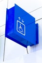 Blue square handicap sign with wheelchair elevator on w Royalty Free Stock Photo