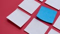 Blue Square Sticky Note Standing Out from White Notes on a Vibrant Red Background Mockup for Business Concepts Royalty Free Stock Photo