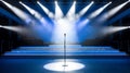 Blue Stage Set with Microphone Under a Bright Spotlight Royalty Free Stock Photo