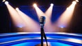 Blue Stage Set with Microphone Under a Bright Spotlight Royalty Free Stock Photo