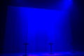 Blue stage spotlights with three stools