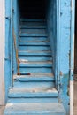 Blue stairs with a broom