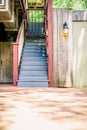 Blue and Red Staircase Outdoors with a Glowing Lamp Beside Royalty Free Stock Photo